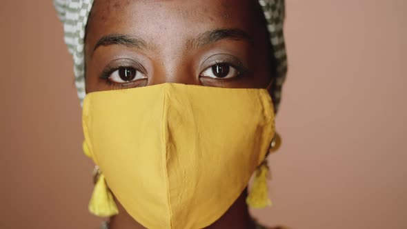 Portrait of Young Black Woman in Turban and Face Mask