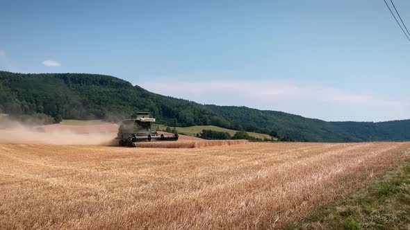 Tractor working in wheat fields at summer