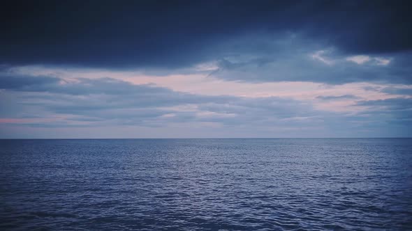 Rippling Sea Water Under The Dramatic Sky In Dunstanburgh, England - Wide Shot