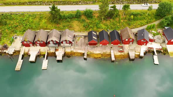 Aerial view of Fairy tale like cottages on the bank of a beautiful lake - Fly away view