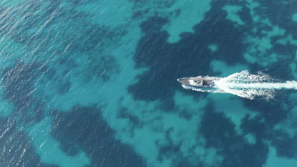 Speed boat cruising in blue Aegean sea, Greece, Cyclades.