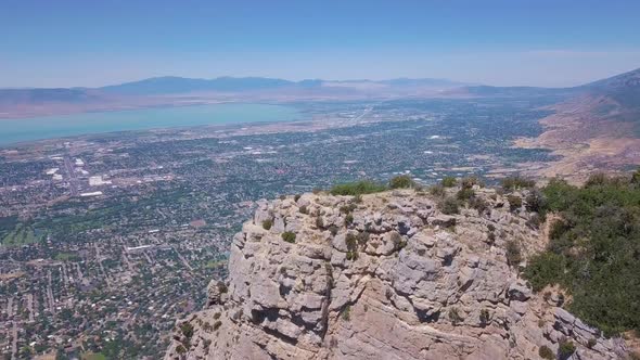 180 degree drone shot of American flag waving in the wind overlooking Provo Utah