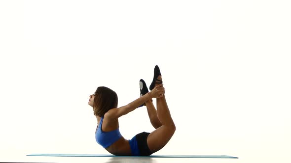 Gymnast in Pose on the Stomach Does Stretch