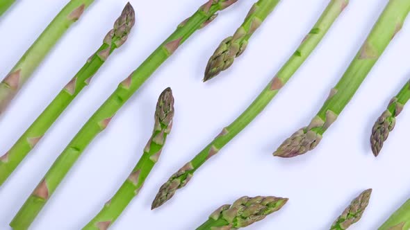 Collage of Different Rotating Vegetables on a White Background Carrots Peas Asparagus Radishes