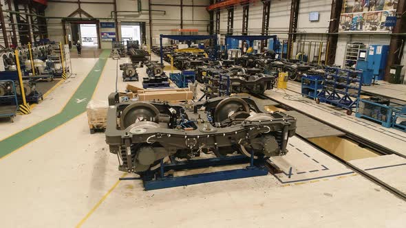 Closeup of a Drone Flying Over a Subway Car Chassis in an Assembly Shop