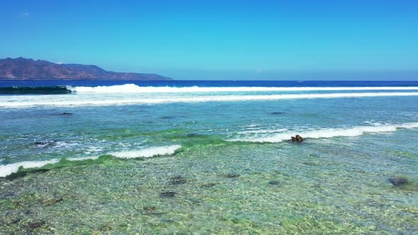 Aerial drone shot nature of beautiful island beach break by shallow water with white sandy backgroun