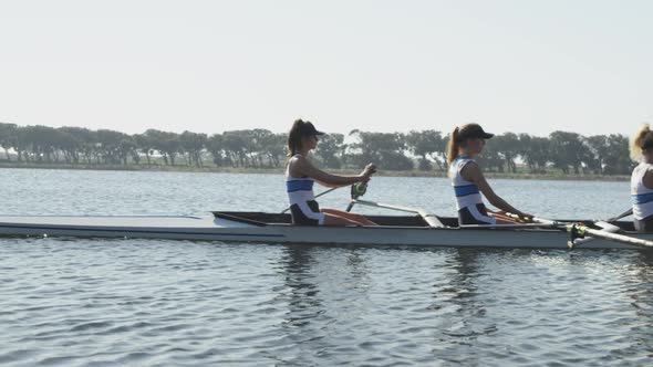 Female rowing team training on a river