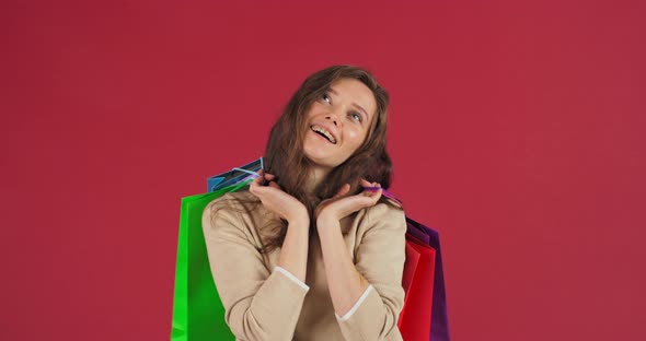 Portrait of Happy Young Caucasian Woman Shopaholic Customer Holding Colorful Shopping Bags Package