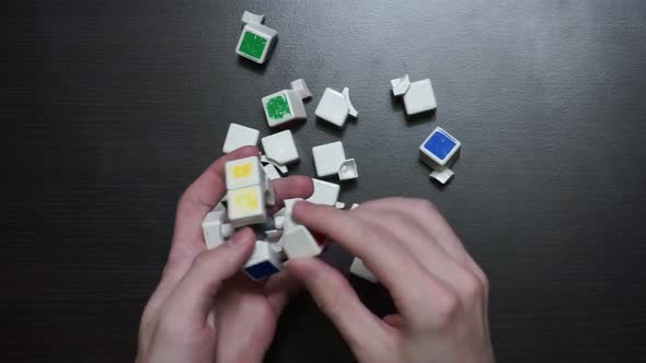 Man collects rubik's cube with his hands