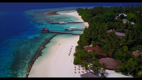 Aerial top down tourism of tranquil bay beach break by turquoise lagoon with white sand background o