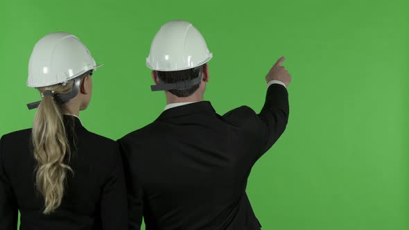 Rear View of Male Engineer Pointing Standing Along with Female Engineer, Chroma Key