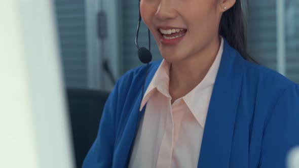 Businesswoman Wearing Headset Working Actively in Office