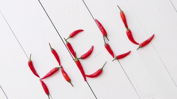 A Word HELL Formed with Small Red Chilli Peppers