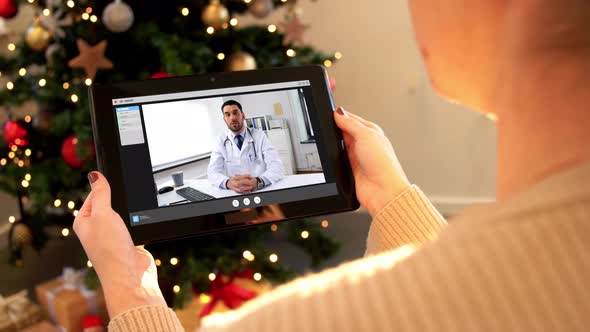 Woman with Tablet Pc Has Video Call with Doctor