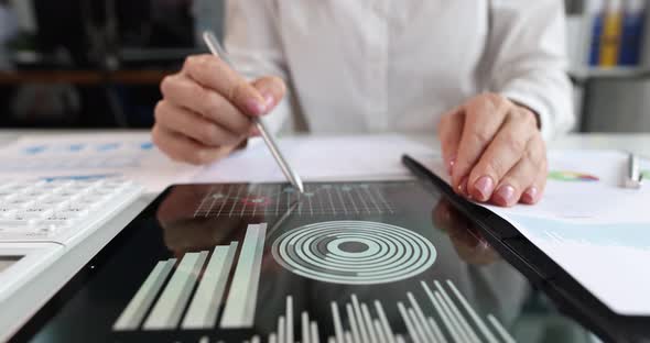 Female Hands Mark Growth Points on the Chart Closeup Tablet