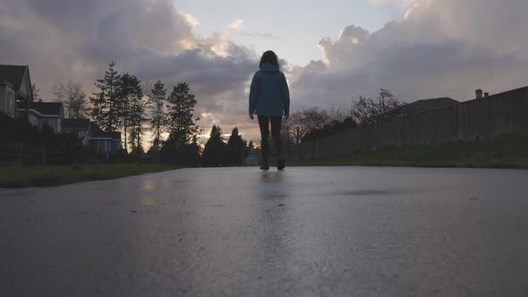 Woman Walking on a Path in a Residential Neighborhood of Modern City Suburbs