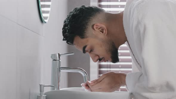 Side View Arab Spaniard Indian Arab Man Guy Opens Faucet Near Washbasin at Home in Hotel Bathroom