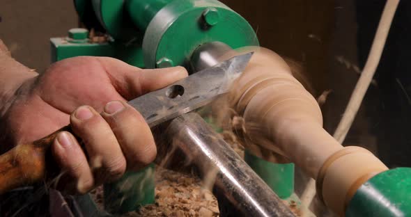 Closeup of carpenter turning wood on a lathe