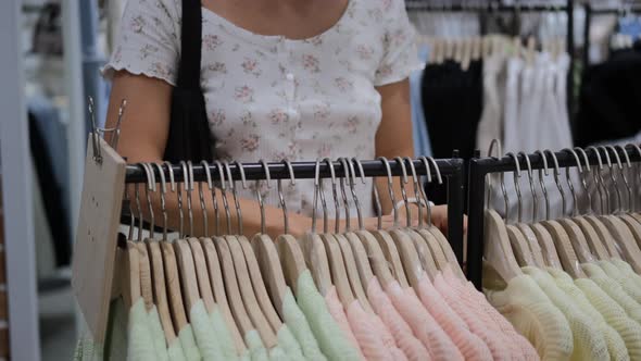 Customer in Apparel Store Choosing Pastel Color Cardigan Trendy Outfit From Massmarket Shop in Mall