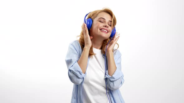 Happy Woman Listening Music and Dancing in Headphones Music Lover