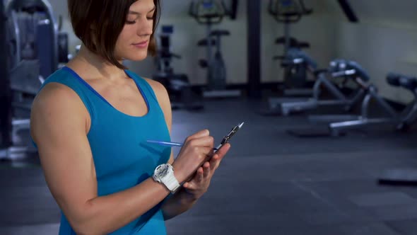 Fitness Woman Poses at the Gym