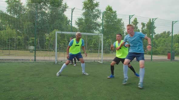 Soccer Players Jostling for Position on Football Pitch at Daybreak