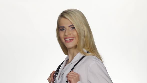 Female Doctor with Stethoscope Smiling To Camera. White