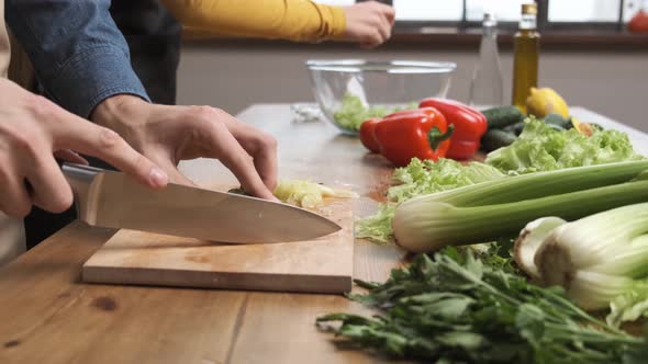 Cooking Salad at Home Man Hands Slicing a Cucumber for a Salad