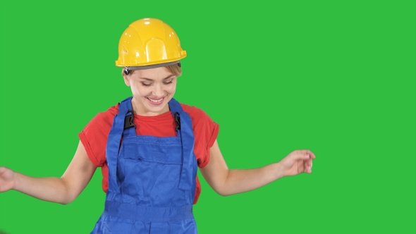 Woman in construction helmet dancing on a Green Screen, Chroma Key.