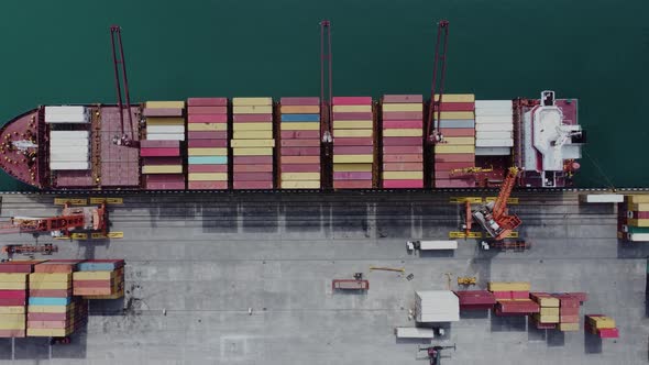 Aerial top view of cargo ship standing in the port