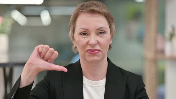 Disappointed Businesswoman Doing Thumbs Down 