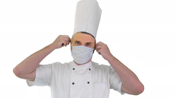 Male Chef Cook Taking Medical Mask Off and Smiling To Camera on White Background