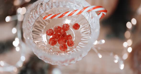 Pouring Sparkling Wine Into a Glass with Berries