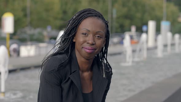 pensive lonely young black african businesswoman thinking alone in the city