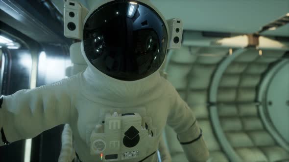 Astronaut Inside the Orbital Space Station alt