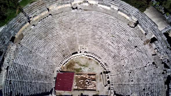 High angle drone aerial view of ancient greek rock cut lykian empire amphitheatre and tombs in Myra