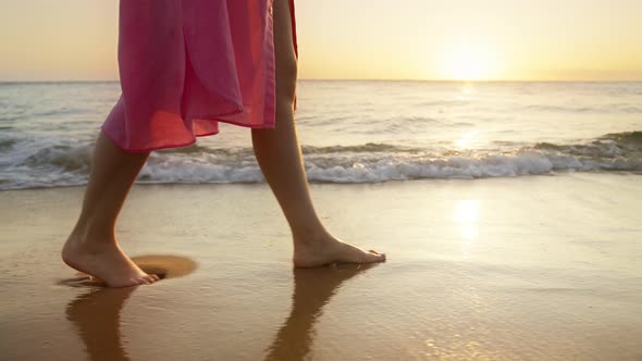 Female Tourist on Summer Vacation Walking in Golden Liquid By Ocean Island Shore