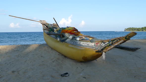 Traditional yellow catamaran fishing boat at the beach 