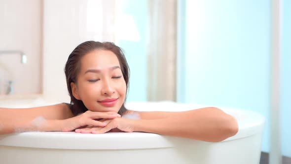 Young asian woman relax in bathtub