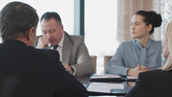 Business Investors Negotiating In Conference Room