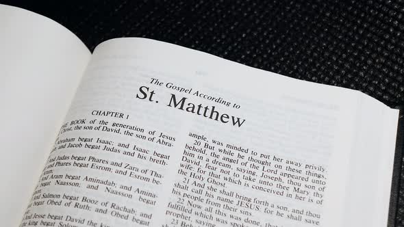 Close Up Shot of  Bible Page Turning to the book of Matthew