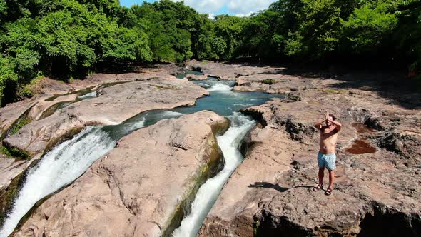 Practicing Yoga next to Malacatiupan Waterfalls Aerial