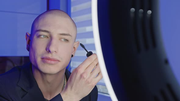 Caucasian Bald Gay Influencer Creating New Makeup Tutorial Using Mascara for His Followers Talking