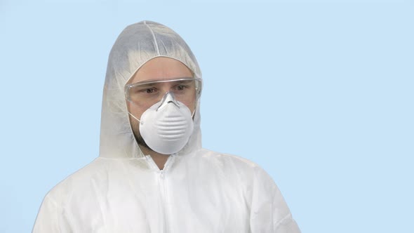 Young Man Wearing Antiviral Protective Clothing with Mask and Glasses