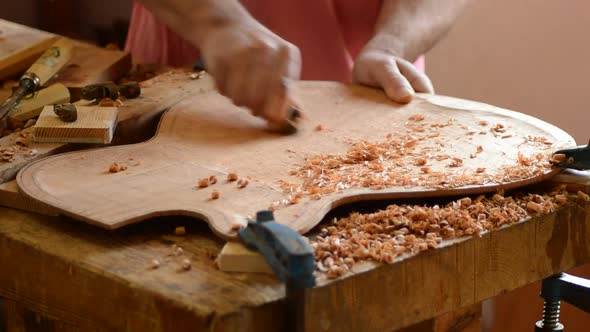 Luthier Sanding a New Guitar