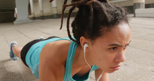 Front view of young African American woman exercising in the city 4k