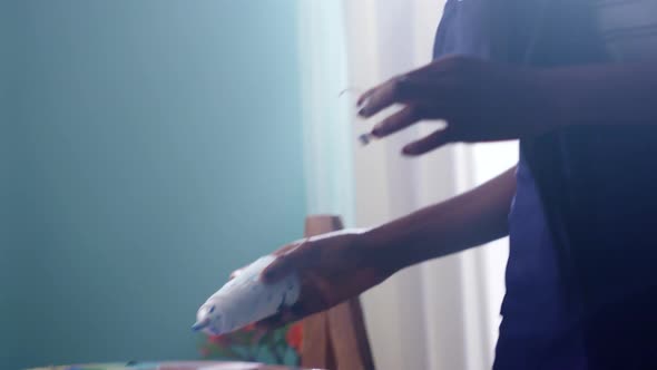 Woman Artist Is Pouring Dye on Palette