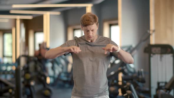 Focused Fitness Man Doing Exercises at Gym. Sportsman Warming Up in Sport Club