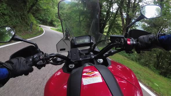 POV Biker Rides on a Motorbike By Forested Mountain Road in Italy