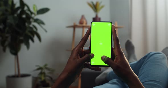 African Man Typing Message on Mock Up Screen with Trecking Markers, Guy Using Smartphone and